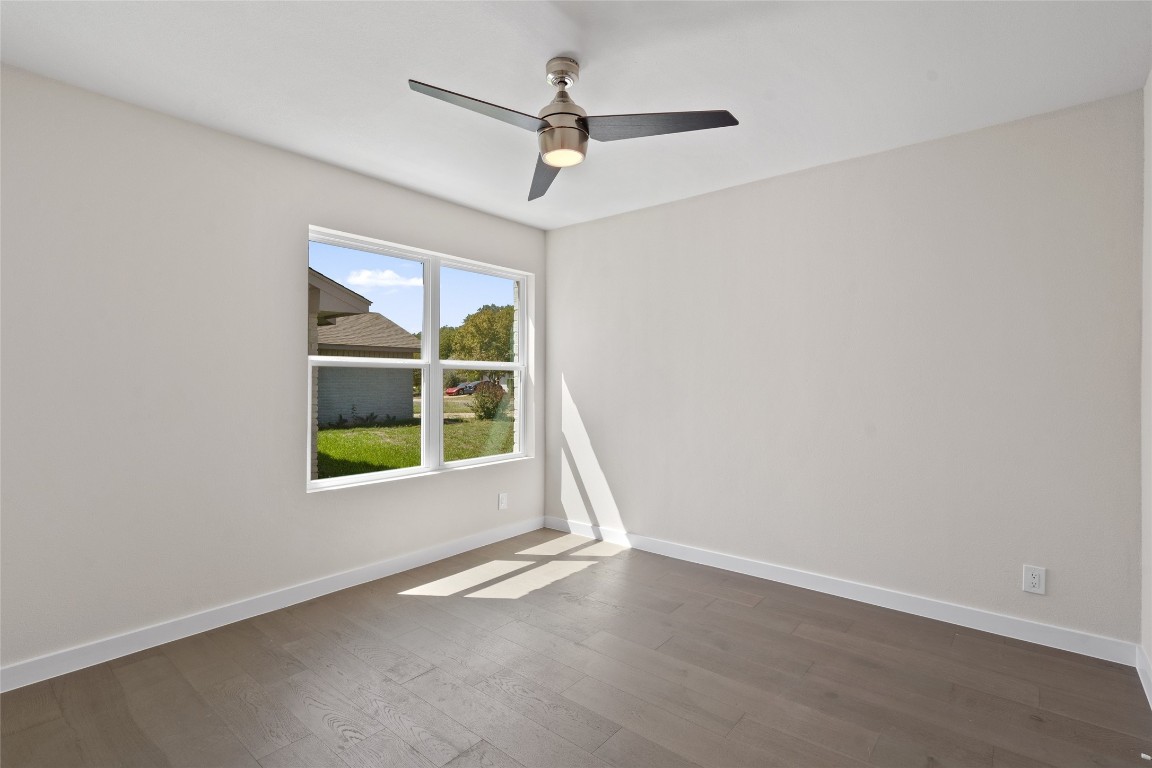6901 Windrift Way Austin, TX 78745 - Photo 17 of 30 Unfurnished room with wood-type flooring and ceiling fan