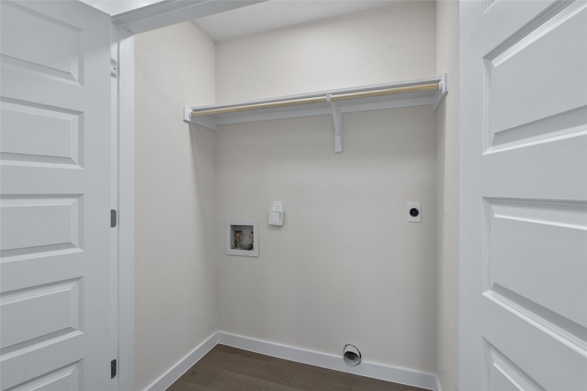 6901 Windrift Way Austin, TX 78745 - Photo 19 of 30 Laundry area featuring dark wood finished floors, hookup for an electric dryer, and washer hookup