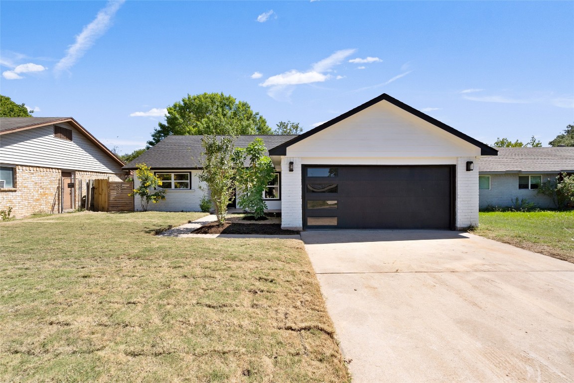 6901 Windrift Way Austin, TX 78745 - Photo 2 of 30 Ranch-style home featuring concrete driveway, brick siding, and a garage