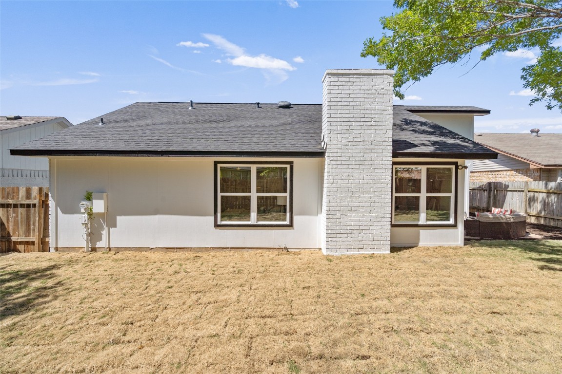 6901 Windrift Way Austin, TX 78745 - Photo 28 of 30 Back of property with a shingled roof, a chimney, and an outdoor hangout area