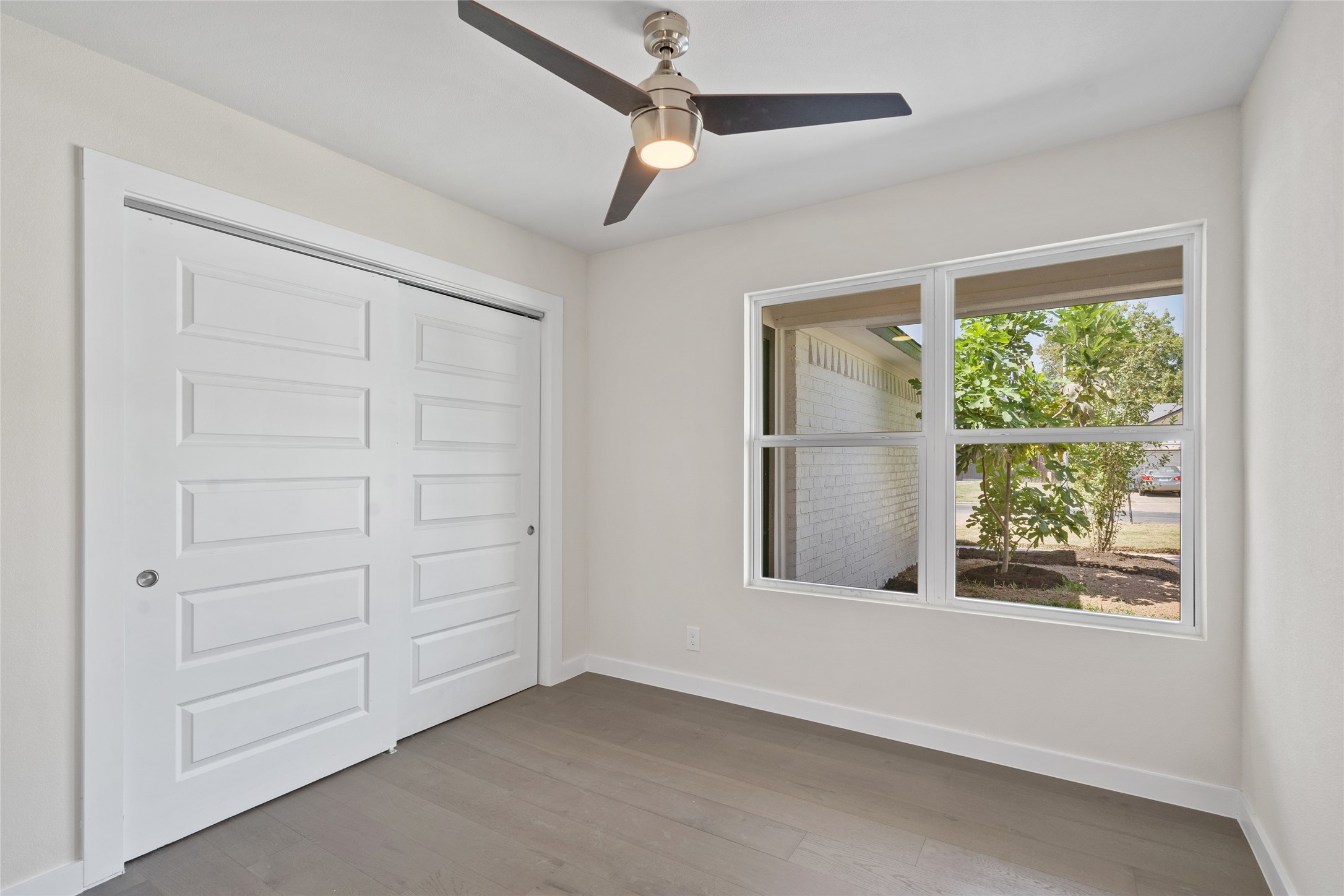 6901 Windrift Way Austin, TX 78745 - Photo 4 of 30 Unfurnished bedroom featuring light wood-style floors, a closet, and a ceiling fan