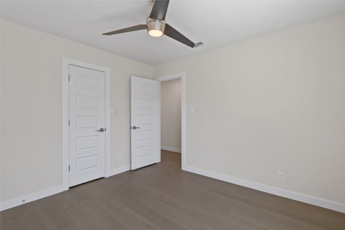 6901 Windrift Way Austin, TX 78745 - Photo 6 of 30 Unfurnished bedroom featuring wood finished floors and a ceiling fan