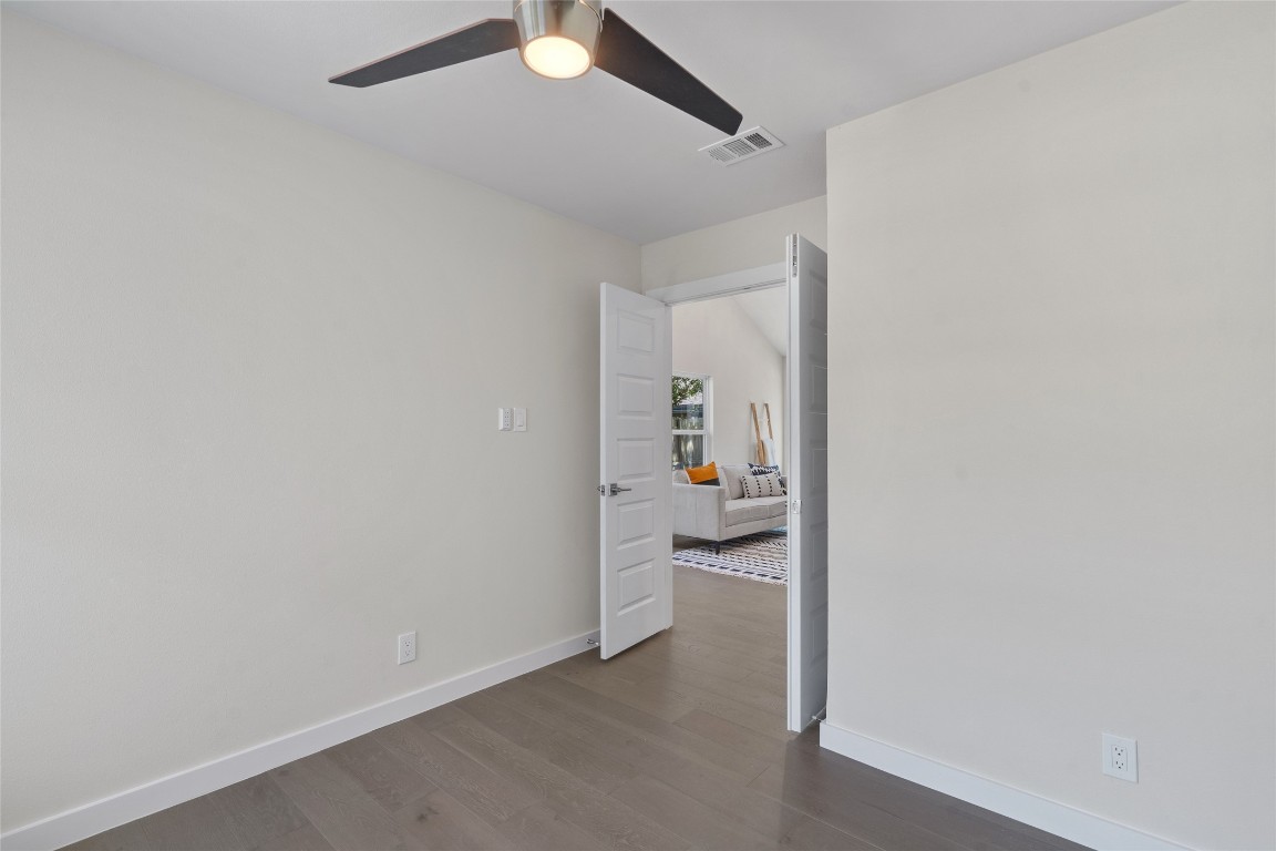 6901 Windrift Way Austin, TX 78745 - Photo 8 of 30 Spare room with dark wood finished floors and ceiling fan