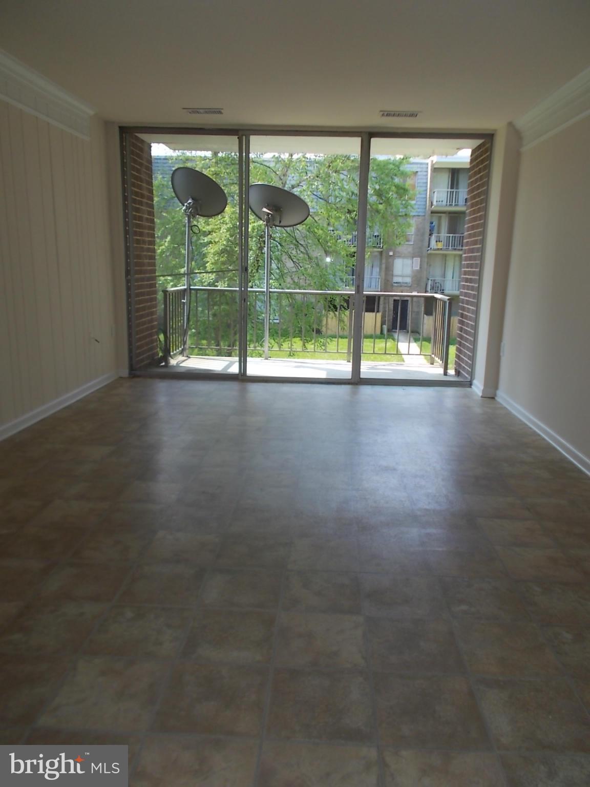 3934 Bel Pre Road, Unit 6 Silver Spring, MD 20906 - Photo 2 of 16 a view of empty room with floor to ceiling windows