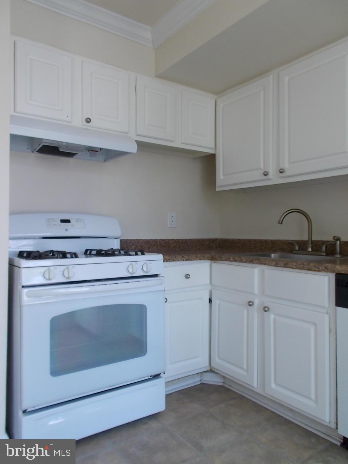 3934 Bel Pre Road, Unit 6 Silver Spring, MD 20906 - Photo 9 of 16 a stove top oven sitting inside of a kitchen
