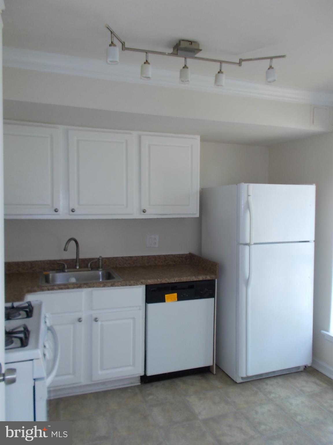 3934 Bel Pre Road, Unit 6 Silver Spring, MD 20906 - Photo 10 of 16 a kitchen with a sink and a refrigerator