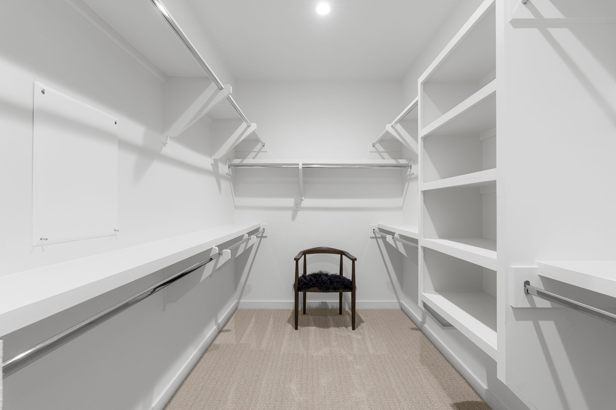 2520 Sutherland Street Austin, TX 78746 - Photo 19 of 26 Customizable closet solutions offer ample storage space within this pristine dressing area.