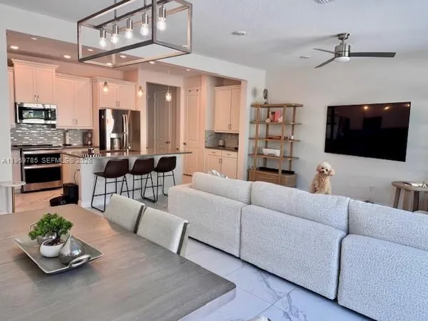 a living room with furniture and a flat screen tv
