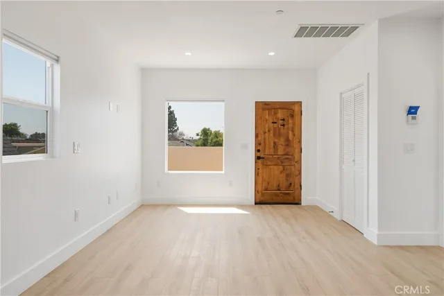 a view of a kitchen with a sink and a refrigerator