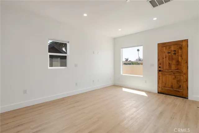 a view of a kitchen with refrigerator and white cabinets