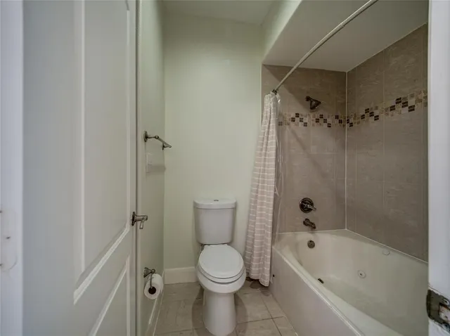 a bathroom with a toilet and a bathtub