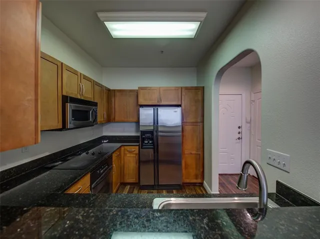 a kitchen with a refrigerator and a sink