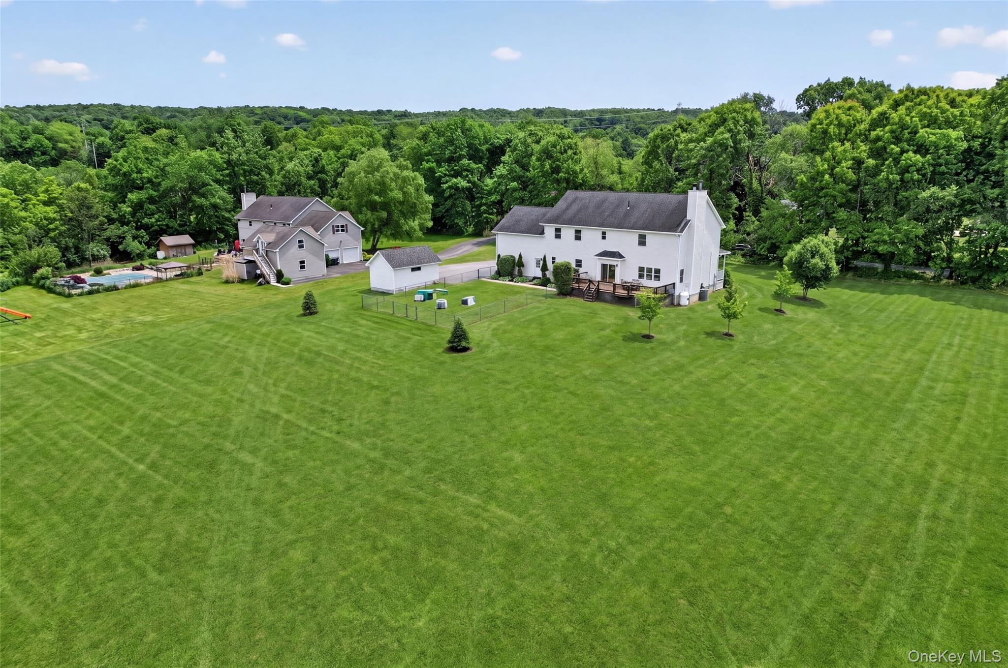 19 Bull Mine Road Chester, NY 10918 - Photo 36 of 42 Spacious green lawn surrounding a two-story residence with mature trees bordering the property