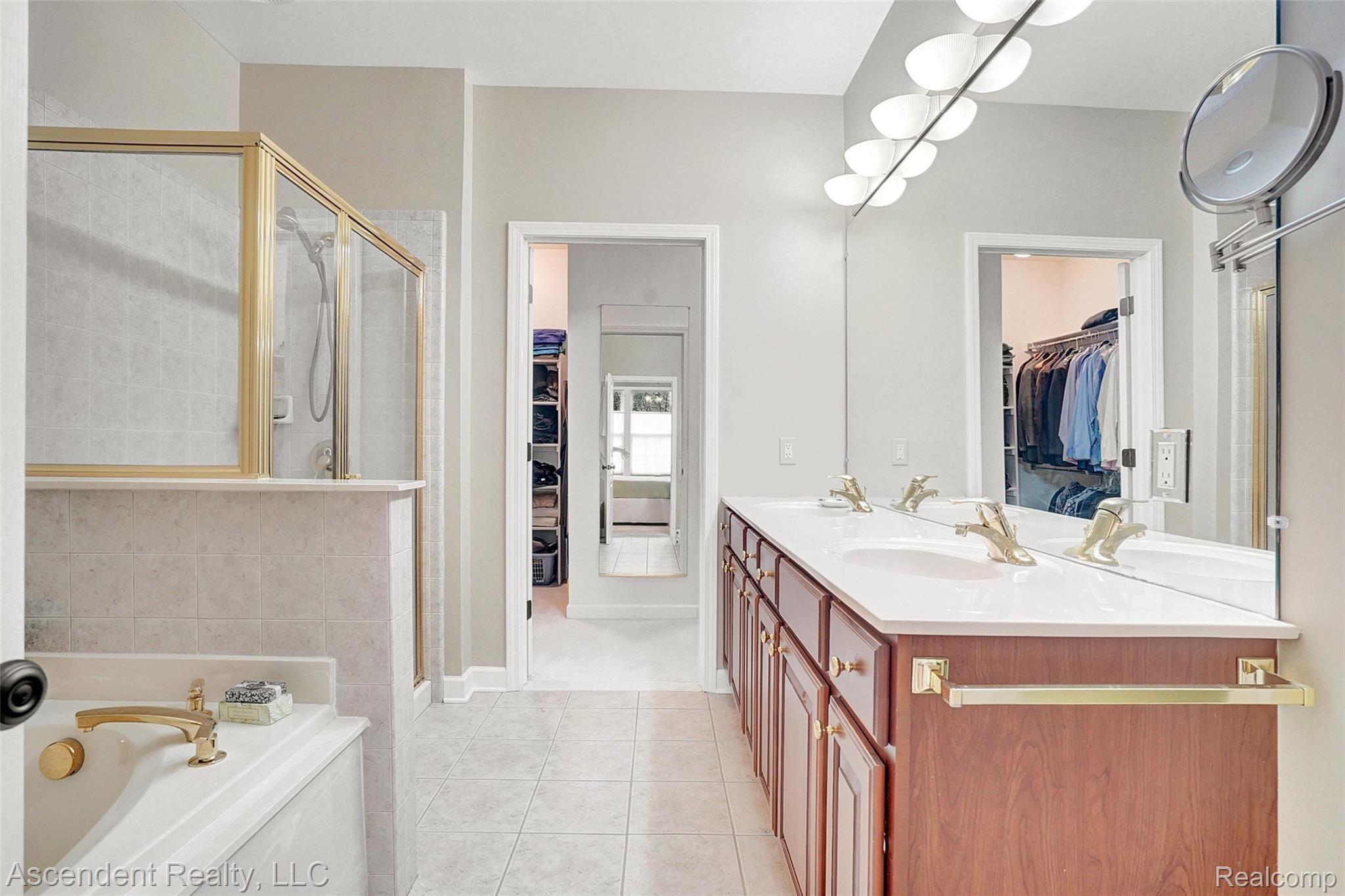 3716 Tremonte Circle Rochester, MI 48306 - Photo 16 of 31 Master bathroom with jetted tub, separate stall shower, his and her lavatories, and entry to master closet