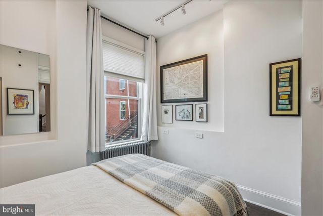 a bedroom with a large bed and a window