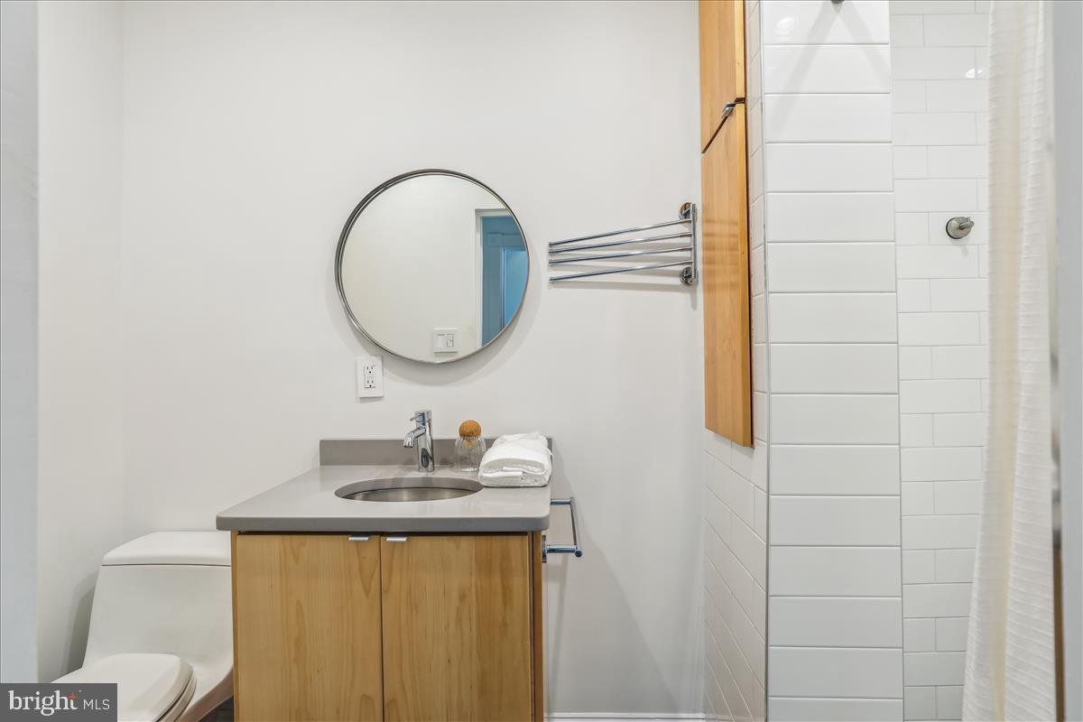 1903 4th Street Northwest Washington, DC 20001 - Photo 25 of 36 a bathroom with a sink a toilet and a mirror