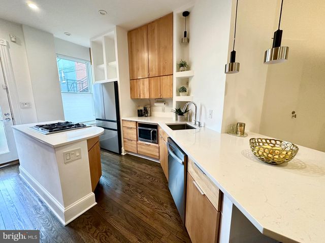a kitchen that has a sink and a stove