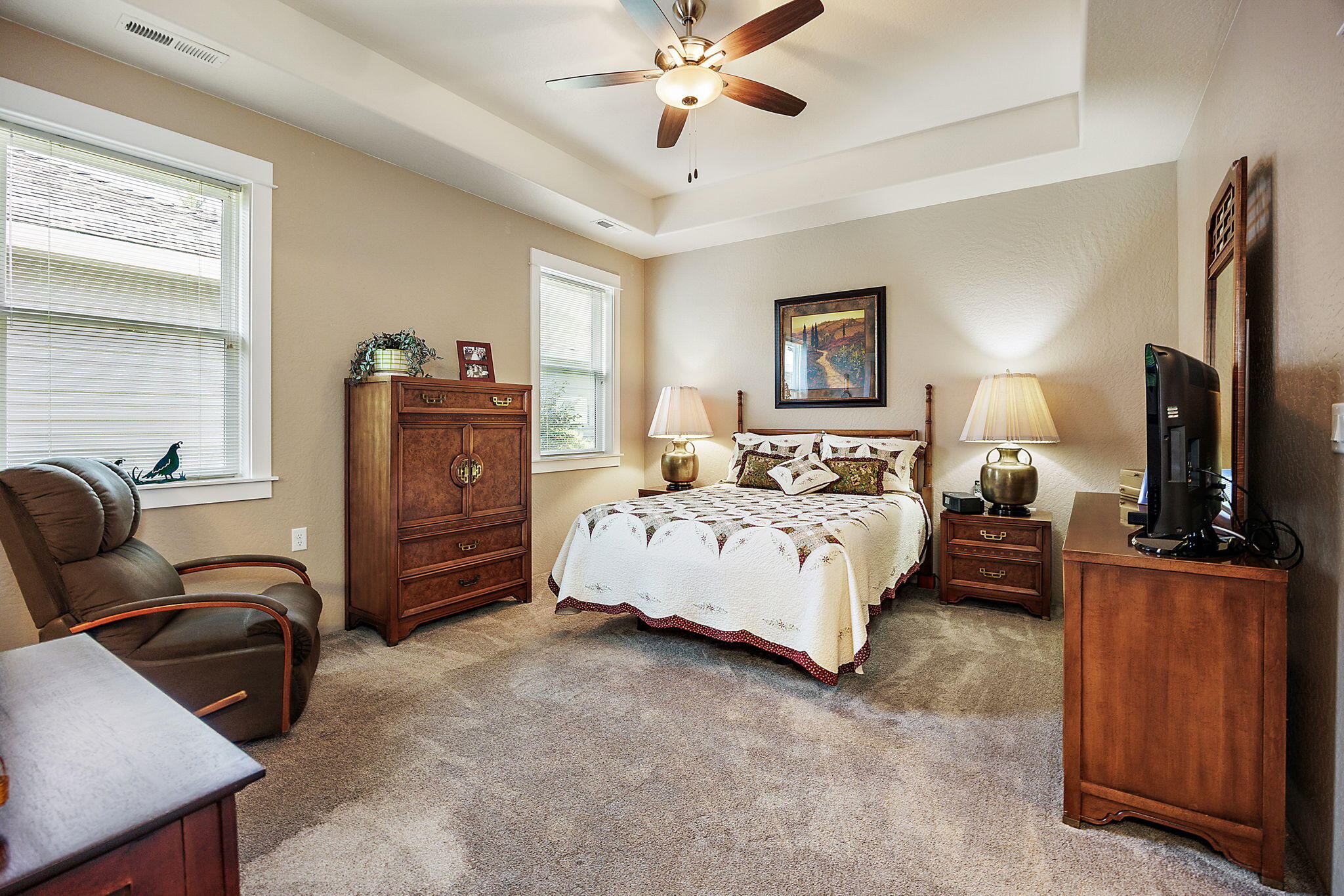 1128 Boulder Ridge Street Central Point, OR 97502 - Photo 27 of 33 a spacious bedroom with a bed and furniture