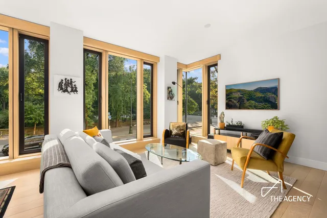 a living room with furniture and large windows