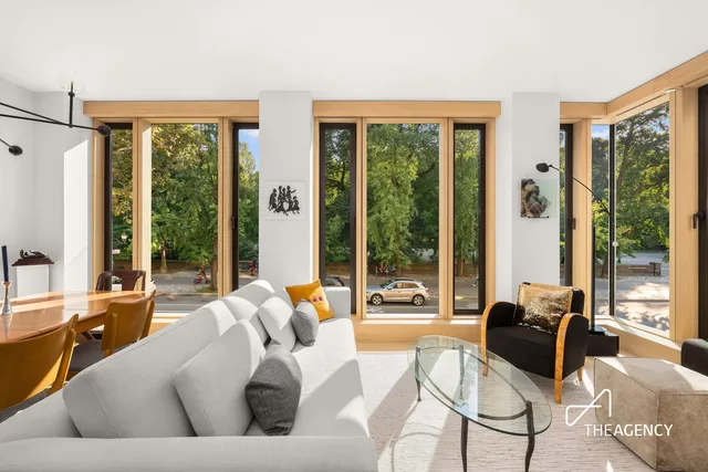 a living room with furniture and floor to ceiling windows