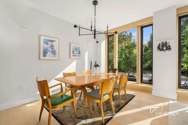 a living room with furniture and large windows