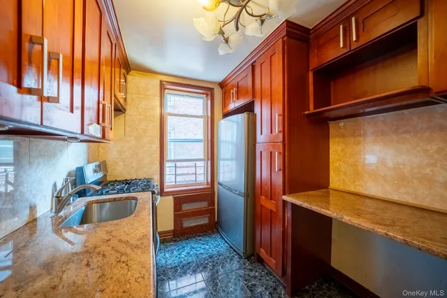 a kitchen with stainless steel appliances granite countertop a sink and a cabinets