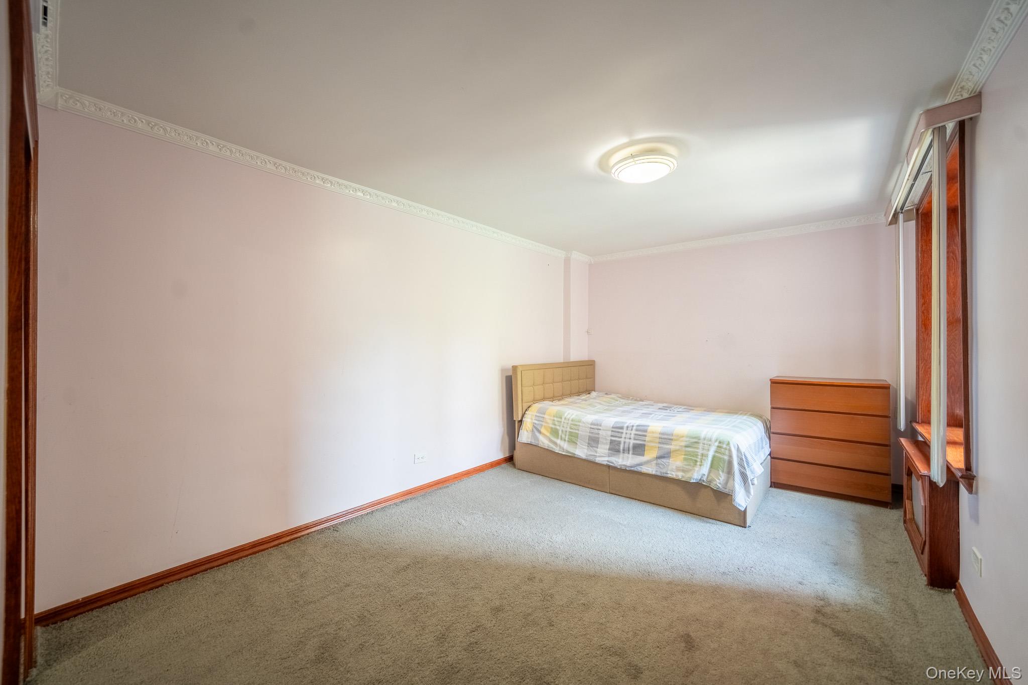 62-59 108th Street, Unit 4N Queens, NY 11375 - Photo 6 of 10 a bedroom with a bed and a window