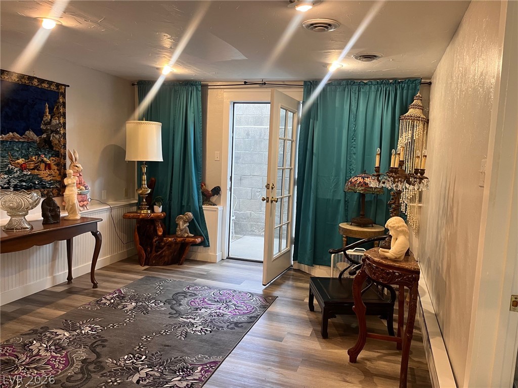 12 Reno Road Ely, NV 89301 - Photo 11 of 21 Doorway featuring wood finished floors, a wainscoted wall, and french doors
