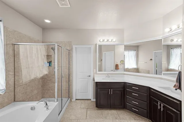 a bedroom with a bed a window and a chandelier