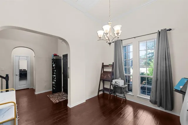 a view of a livingroom with wooden floor and furniture