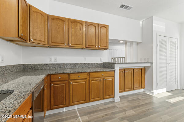 1330 Eddy Road Jacksonville, FL 32211 - Photo 19 of 39 a kitchen with stainless steel appliances granite countertop wooden cabinets a sink and dishwasher with wooden floor
