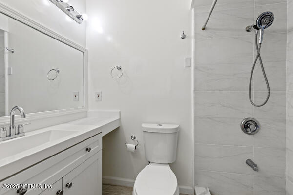 1330 Eddy Road Jacksonville, FL 32211 - Photo 29 of 39 a bathroom with a granite countertop toilet sink and mirror