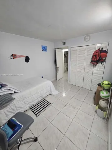 a bed room with a balcony and gym equipment