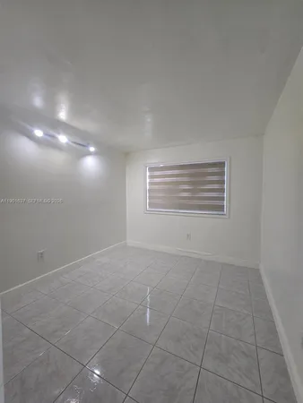 a view of an empty room with a fireplace