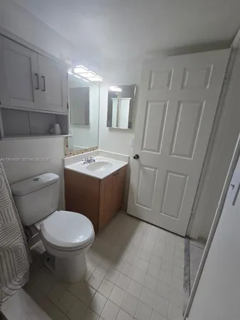 a bathroom with a sink vanity and toilet