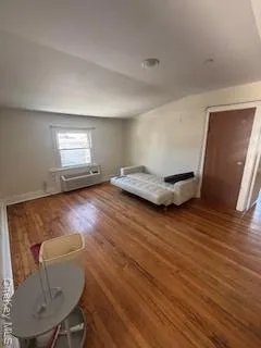 a view of room with window and wooden floor