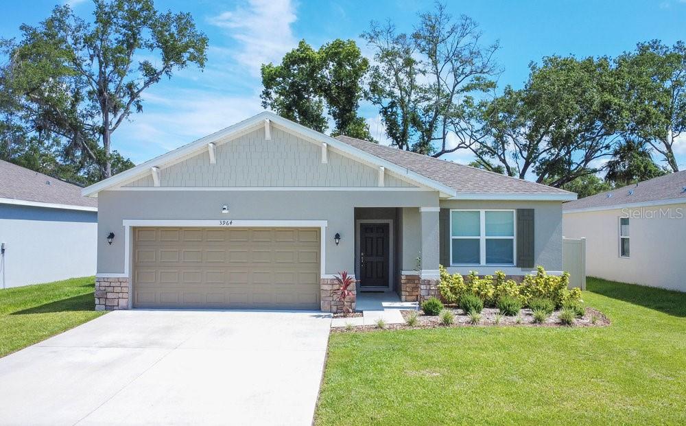 3964 Mayhill Loop Eustis, FL 32736 - Photo 1 of 34 a front view of a house with a yard and garage