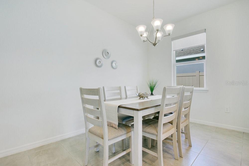 3964 Mayhill Loop Eustis, FL 32736 - Photo 12 of 34 a view of a dining room with furniture and chandelier