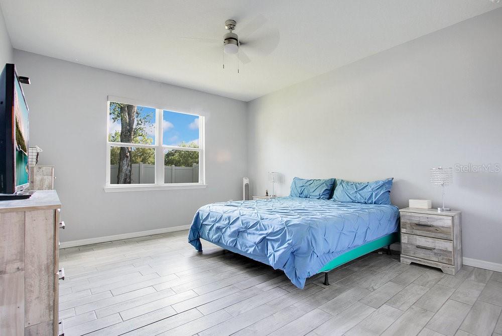 3964 Mayhill Loop Eustis, FL 32736 - Photo 13 of 34 a bedroom with a bed a dresser and a window