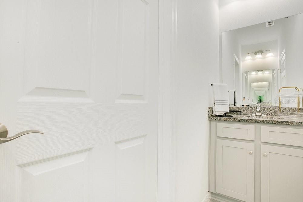3964 Mayhill Loop Eustis, FL 32736 - Photo 20 of 34 a bathroom with a granite countertop sink and a mirror