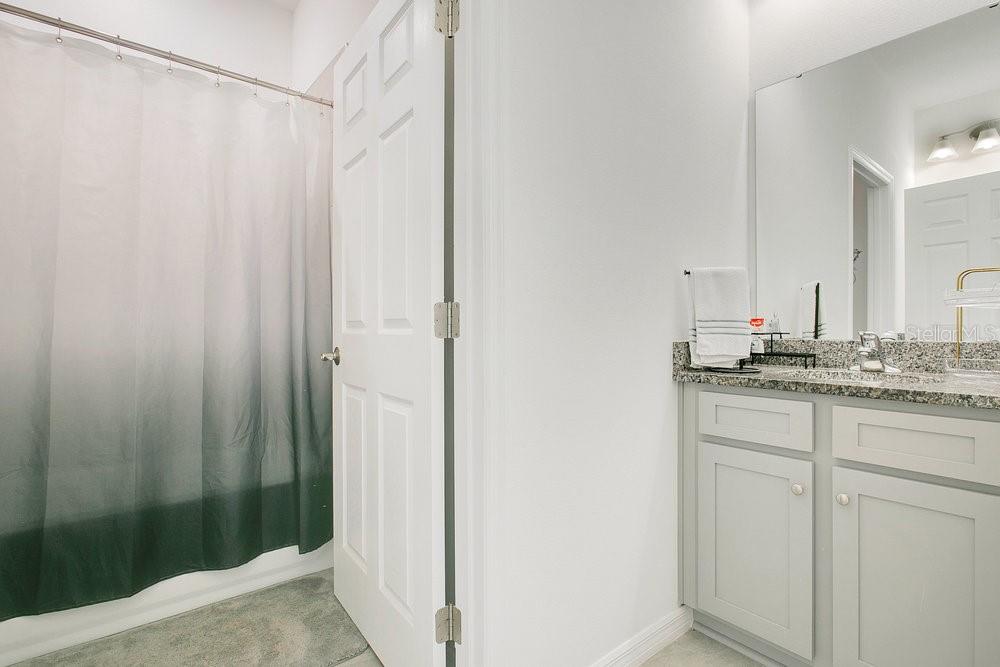 3964 Mayhill Loop Eustis, FL 32736 - Photo 22 of 34 a bathroom with a shower and a sink