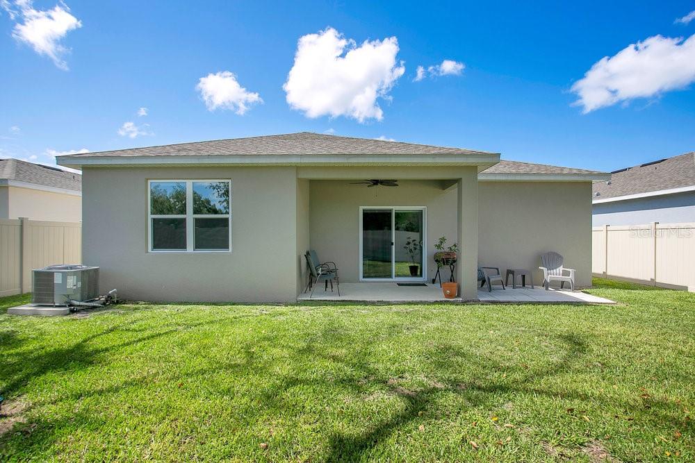 3964 Mayhill Loop Eustis, FL 32736 - Photo 26 of 34 a view of a house with a yard and a large tree