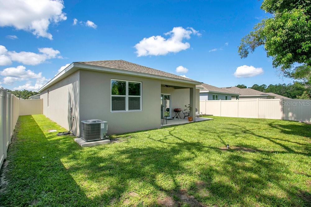 3964 Mayhill Loop Eustis, FL 32736 - Photo 27 of 34 a backyard of a house with table and chairs