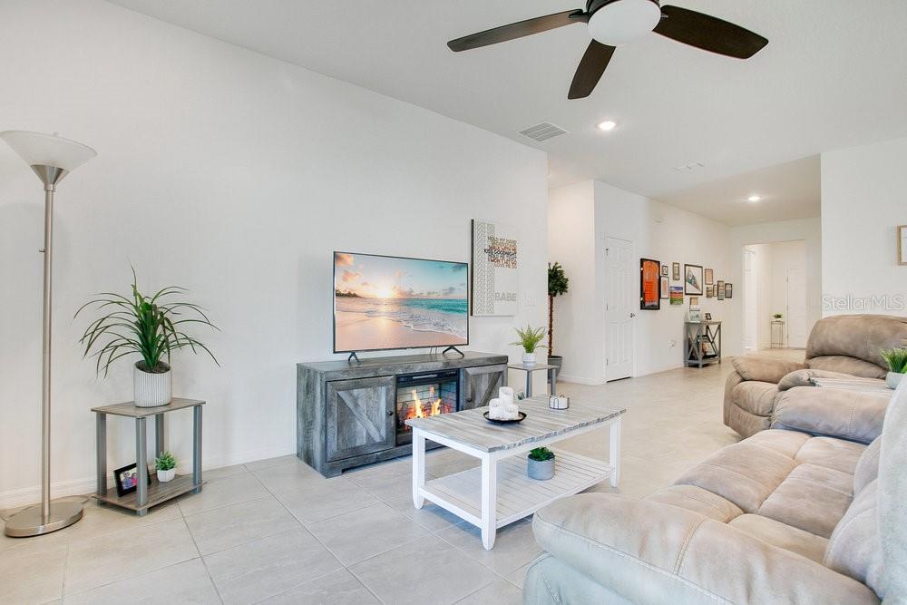 3964 Mayhill Loop Eustis, FL 32736 - Photo 7 of 34 a living room with furniture and a flat screen tv