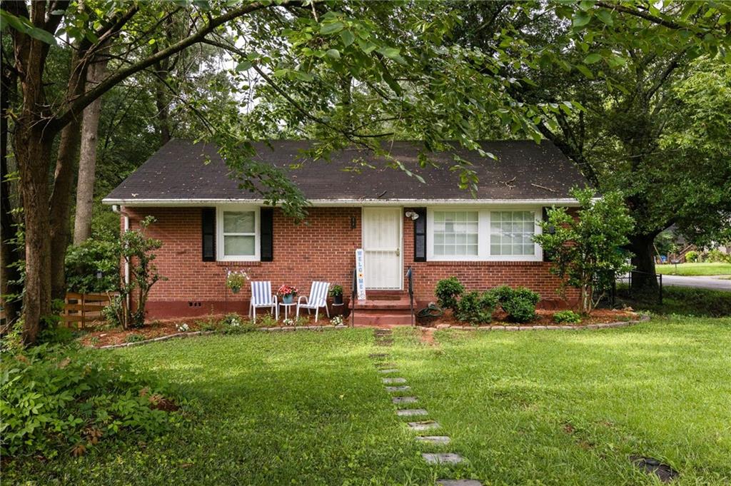 2413 Hillside Avenue Decatur, GA 30032 - Photo 1 of 1 a front view of a house with a garden and yard