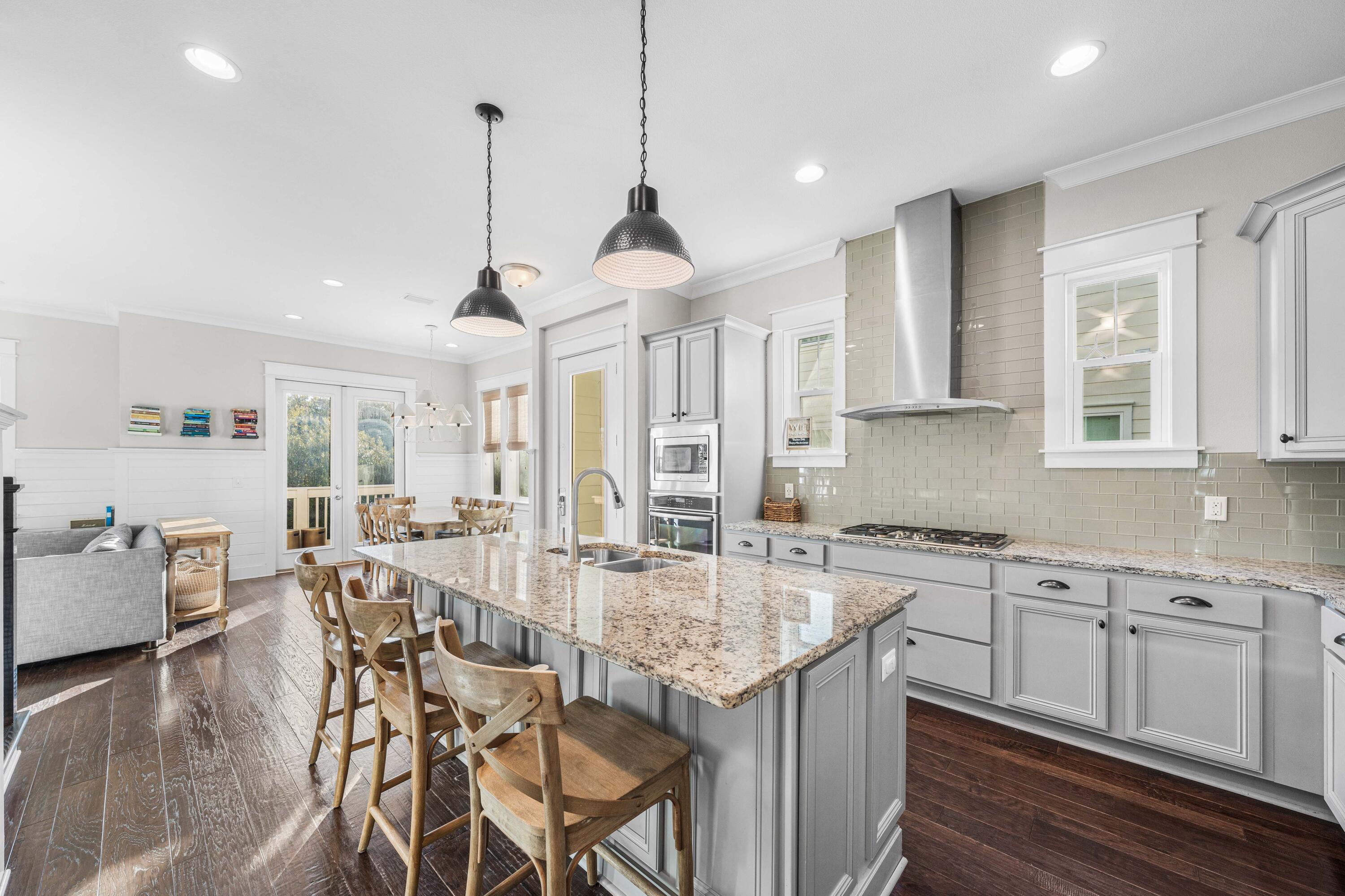 91 Milestone Dr Inlet Beach, Unit B Inlet Beach, FL 32461 - Photo 1 of 51 an open kitchen with granite countertop kitchen island white cabinets and stainless steel appliances