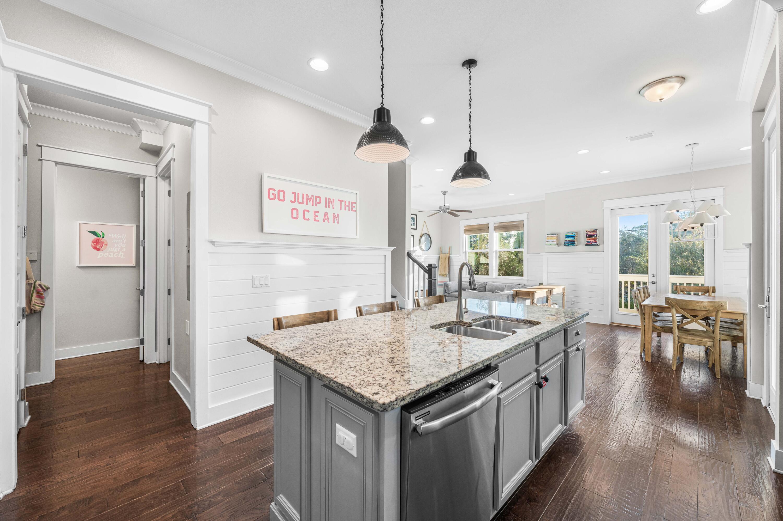 91 Milestone Dr Inlet Beach, Unit B Inlet Beach, FL 32461 - Photo 11 of 51 a kitchen with granite countertop a center island and a wooden floor