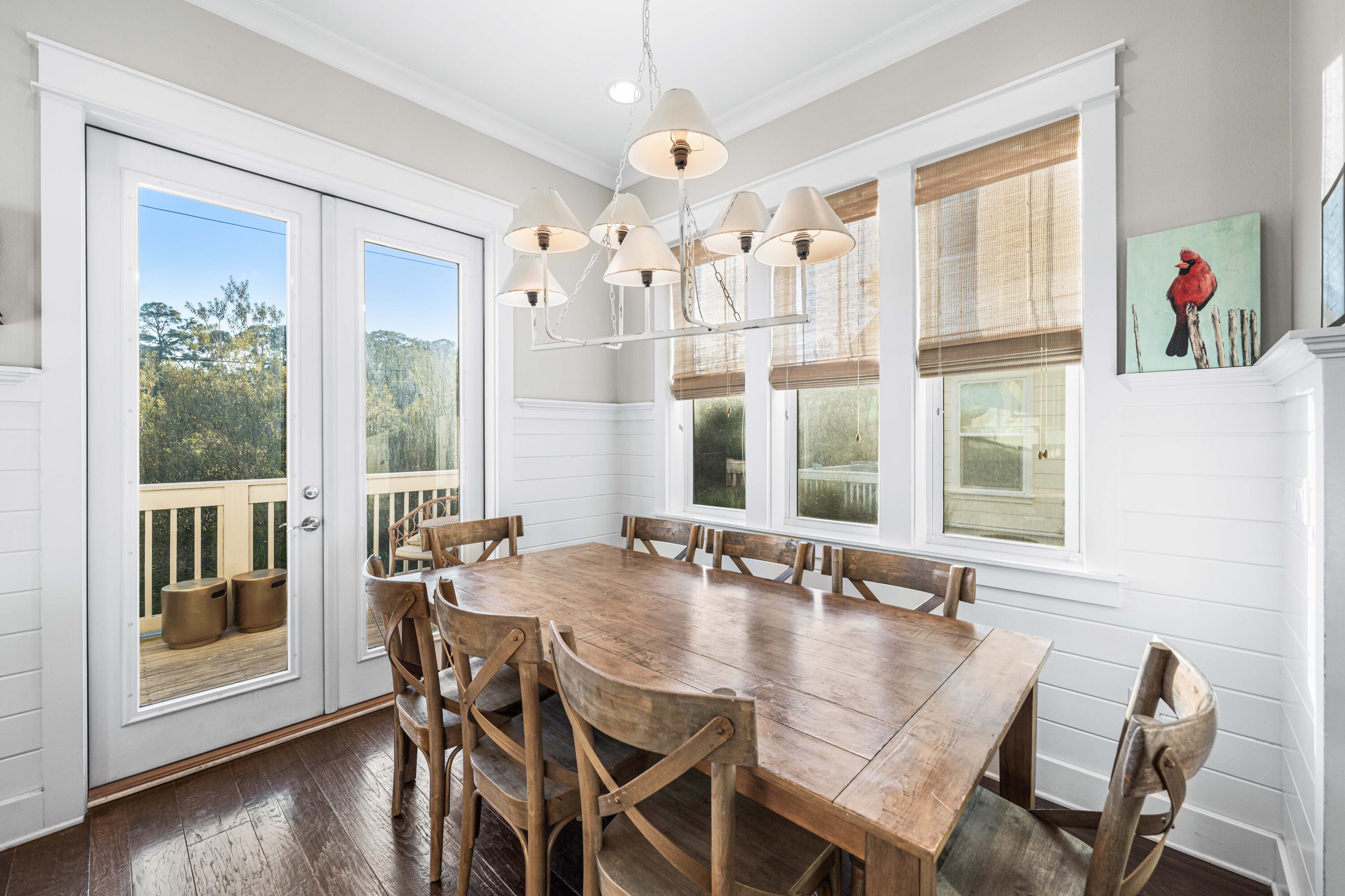 91 Milestone Dr Inlet Beach, Unit B Inlet Beach, FL 32461 - Photo 12 of 51 a view of a dining room with furniture wooden floor and chandelier