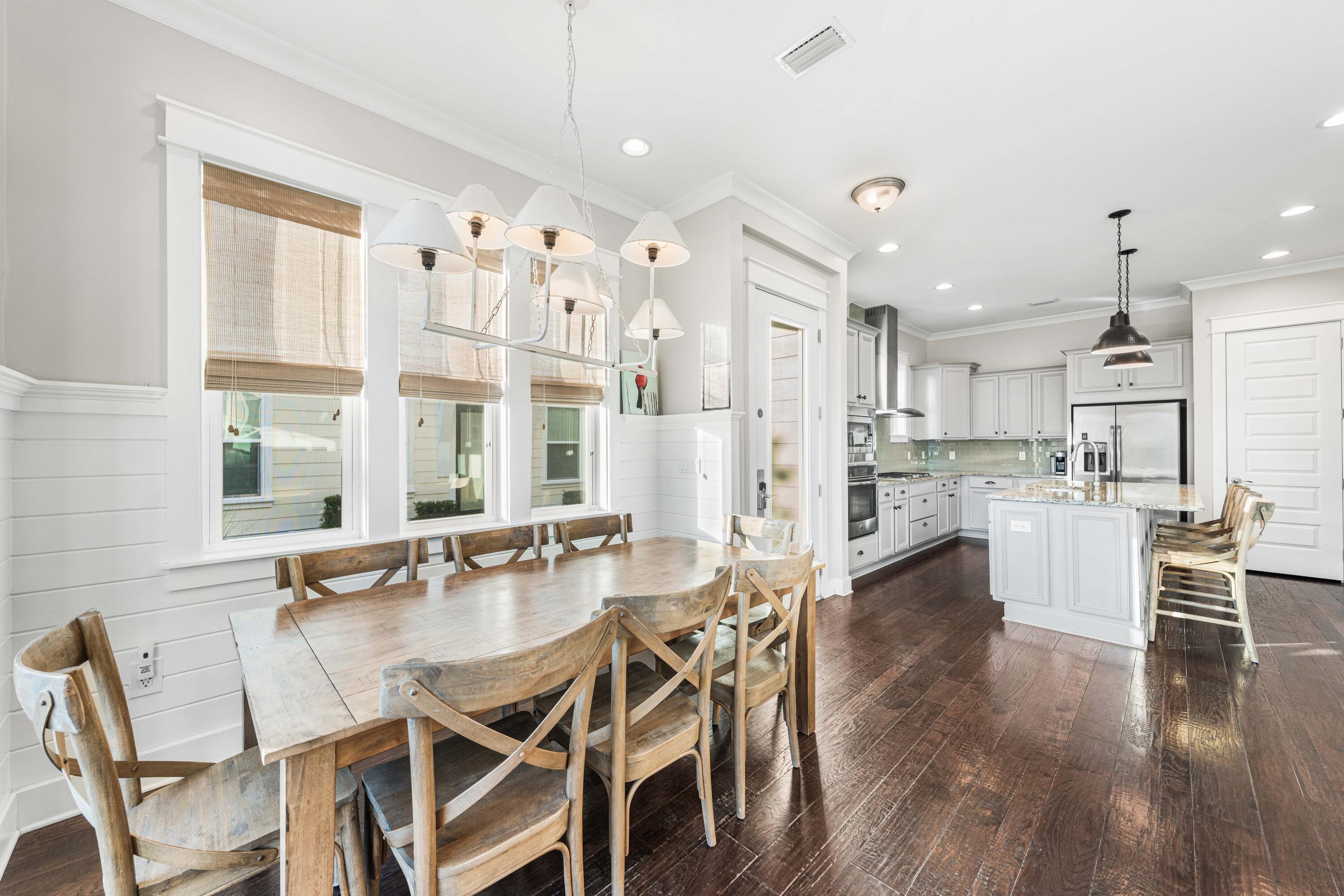 91 Milestone Dr Inlet Beach, Unit B Inlet Beach, FL 32461 - Photo 13 of 51 a dining room with stainless steel appliances kitchen island granite countertop a dining table chairs and white cabinets next to a window