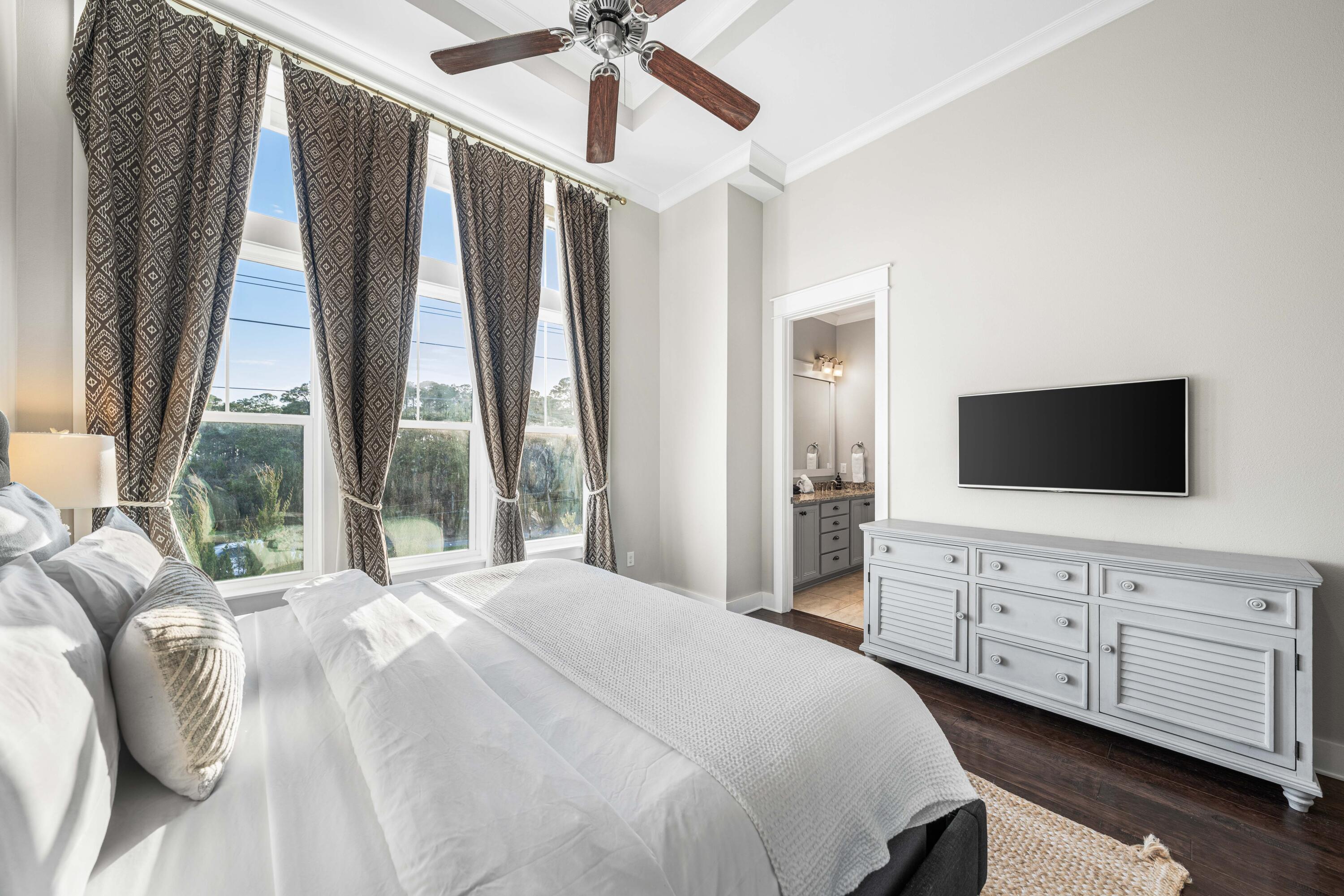 91 Milestone Dr Inlet Beach, Unit B Inlet Beach, FL 32461 - Photo 19 of 51 a bedroom with a large bed and a flat tv screen on dresser